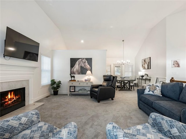 living room featuring an inviting chandelier, light carpet, high vaulted ceiling, and a tiled fireplace