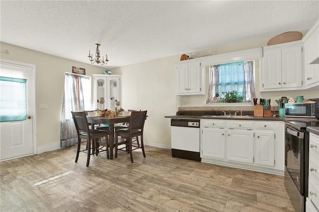 kitchen with dishwasher, range with electric cooktop, sink, and white cabinets