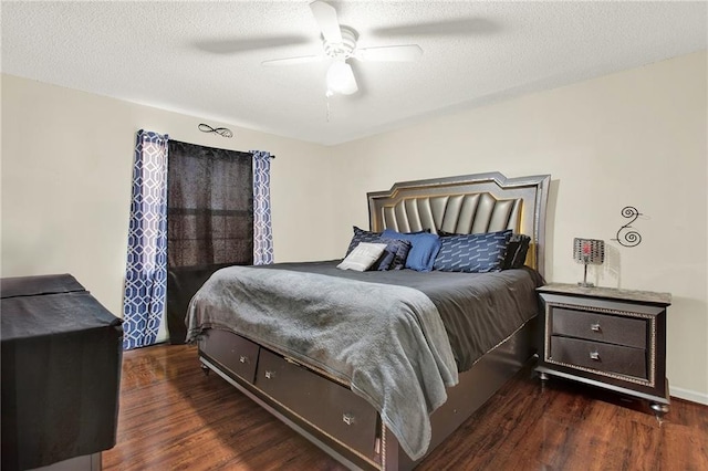 bedroom with a textured ceiling, dark hardwood / wood-style floors, and ceiling fan