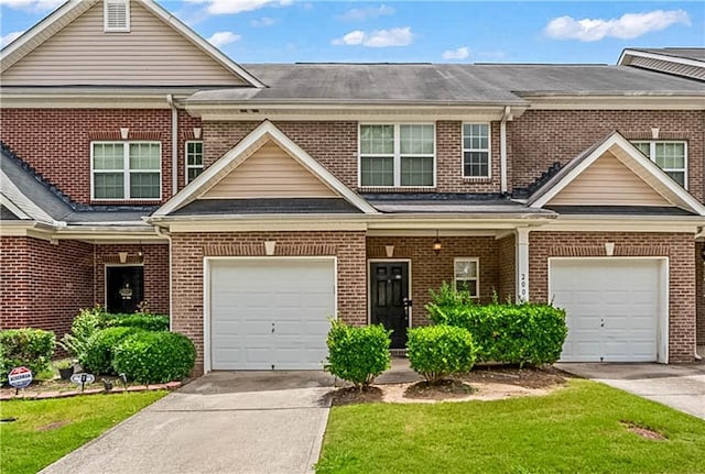 2555 Flat Shoals Rd Unit 2006, Atlanta, GA 30349 - view of front of house with concrete driveway, brick siding, and a front lawn