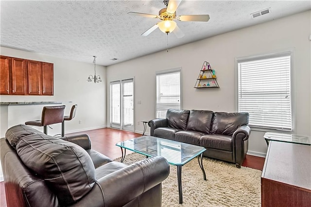 2555 Flat Shoals Rd Unit 2006, Atlanta, GA 30349 - living area featuring wood finished floors, a textured ceiling, and a ceiling fan