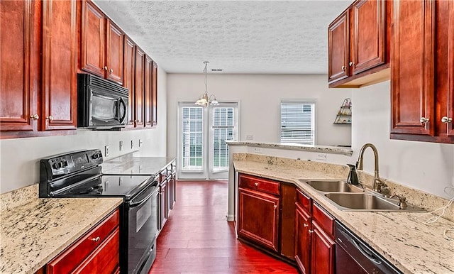 2555 Flat Shoals Rd Unit 2006, Atlanta, GA 30349 - kitchen featuring black appliances, dark brown cabinets, dark wood-style flooring, a textured ceiling, and a peninsula