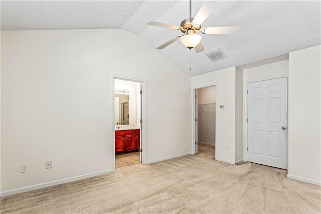 2555 Flat Shoals Rd Unit 2006, Atlanta, GA 30349 - unfurnished bedroom featuring vaulted ceiling, light colored carpet, a spacious closet, ensuite bathroom, and a closet