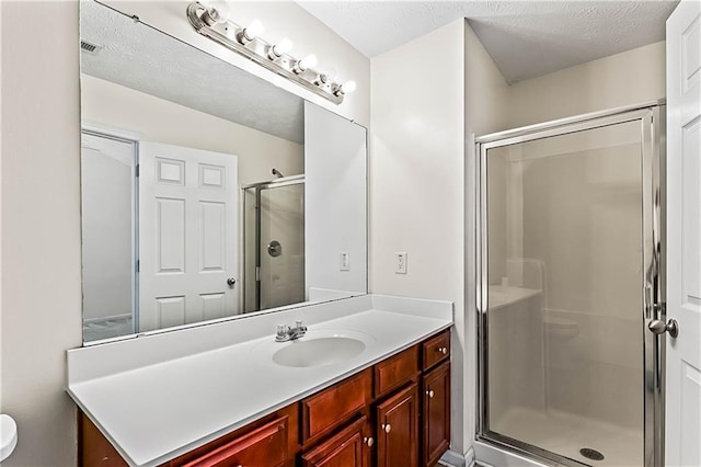 2555 Flat Shoals Rd Unit 2006, Atlanta, GA 30349 - bathroom featuring vanity, a stall shower, and a textured ceiling
