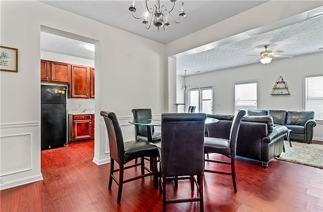 2555 Flat Shoals Rd Unit 2006, Atlanta, GA 30349 - dining space featuring a chandelier, dark wood-style flooring, a ceiling fan, and a textured ceiling