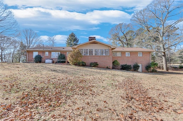 back of house with a lawn