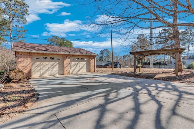 exterior space featuring a gazebo, a garage, and an outdoor structure