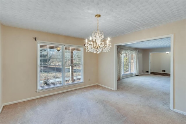 unfurnished room with light carpet, plenty of natural light, and an inviting chandelier