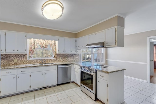 kitchen featuring white cabinetry, appliances with stainless steel finishes, range hood, and sink