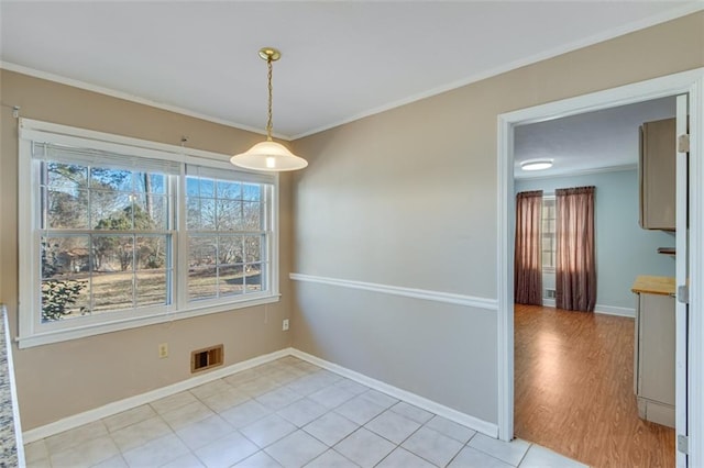 unfurnished dining area featuring light tile patterned floors and ornamental molding