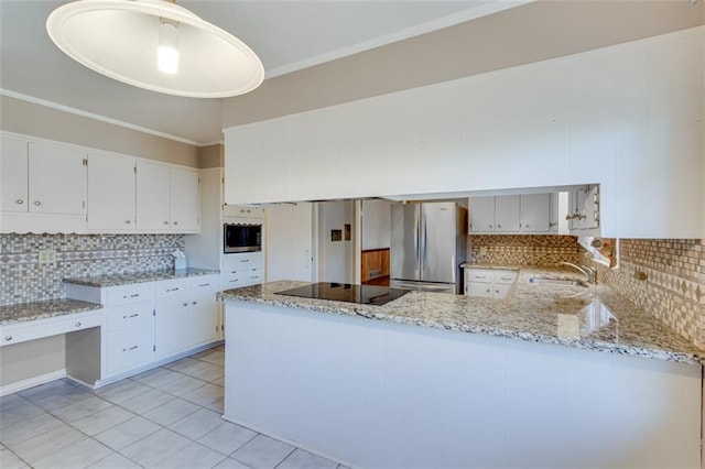 kitchen featuring appliances with stainless steel finishes, hanging light fixtures, light stone counters, white cabinets, and kitchen peninsula