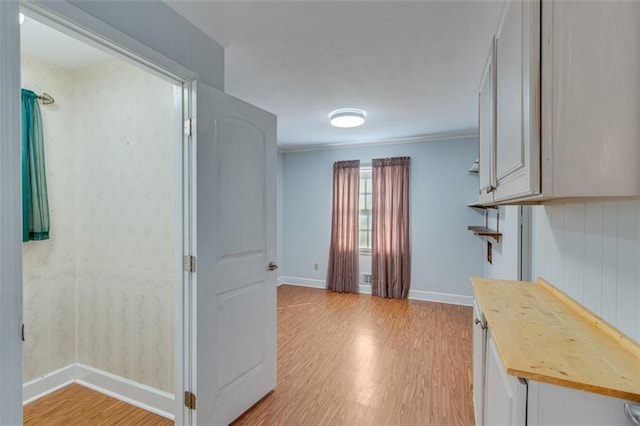 hall featuring ornamental molding and light wood-type flooring