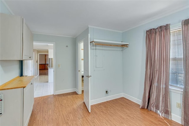 washroom with ornamental molding, a healthy amount of sunlight, and light wood-type flooring