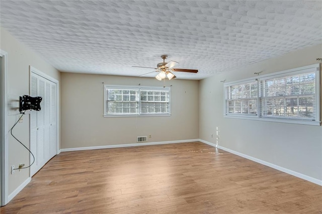 spare room with light hardwood / wood-style flooring and ceiling fan