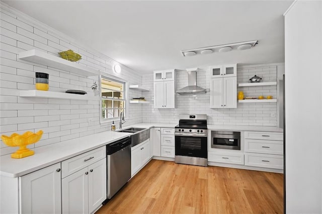 3332 Saint John Dr, East Point, GA 30344 - kitchen with open shelves, appliances with stainless steel finishes, wall chimney exhaust hood, backsplash, and white cabinetry