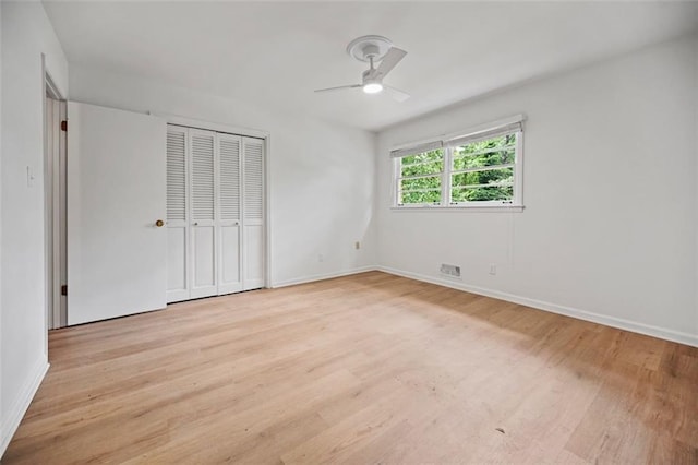 3332 Saint John Dr, East Point, GA 30344 - unfurnished bedroom with light wood-type flooring, baseboards, a ceiling fan, and a closet