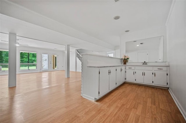 3332 Saint John Dr, East Point, GA 30344 - bar with light wood-style flooring, a sink, and baseboards