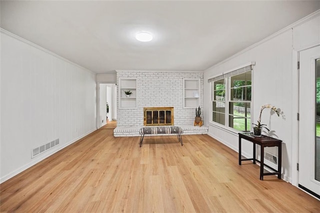 3332 Saint John Dr, East Point, GA 30344 - living room with ornamental molding, light wood-style flooring, and a fireplace