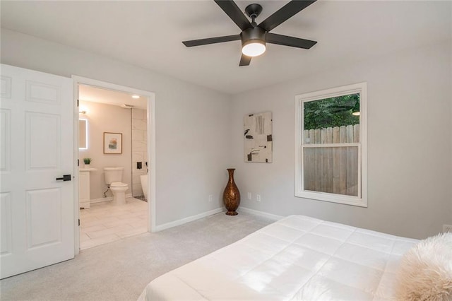 carpeted bedroom with baseboards, a ceiling fan, and ensuite bathroom