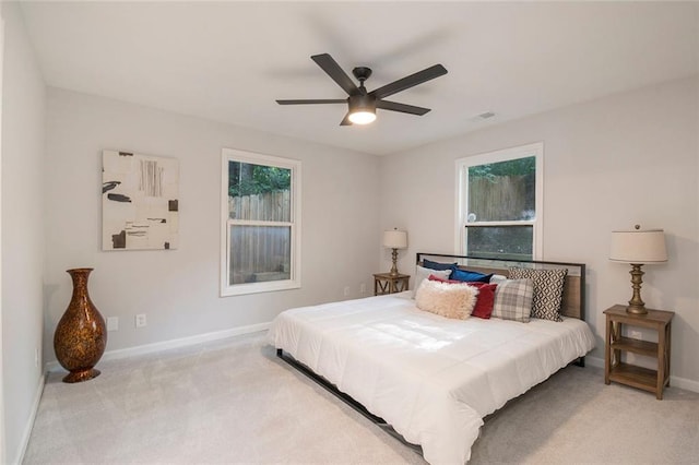 carpeted bedroom with ceiling fan, visible vents, and baseboards