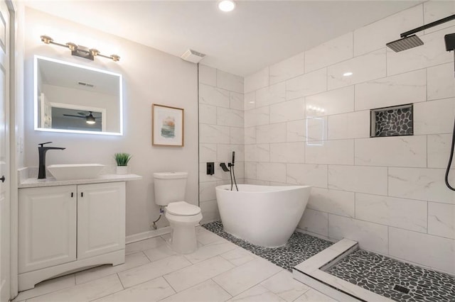 bathroom with a soaking tub, tiled shower, vanity, and toilet