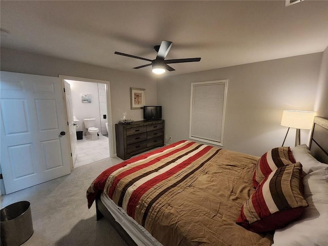 carpeted bedroom featuring a ceiling fan and connected bathroom