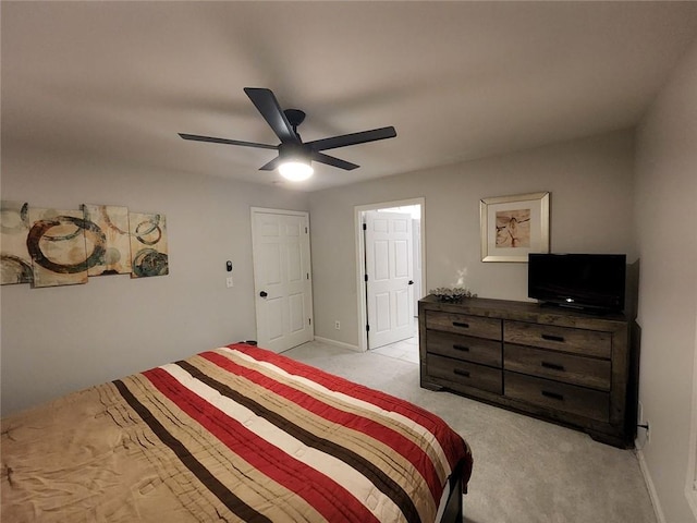 bedroom with light carpet, ceiling fan, and baseboards