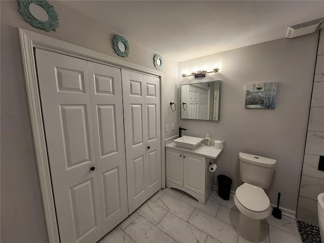 bathroom featuring marble finish floor, visible vents, toilet, vanity, and baseboards