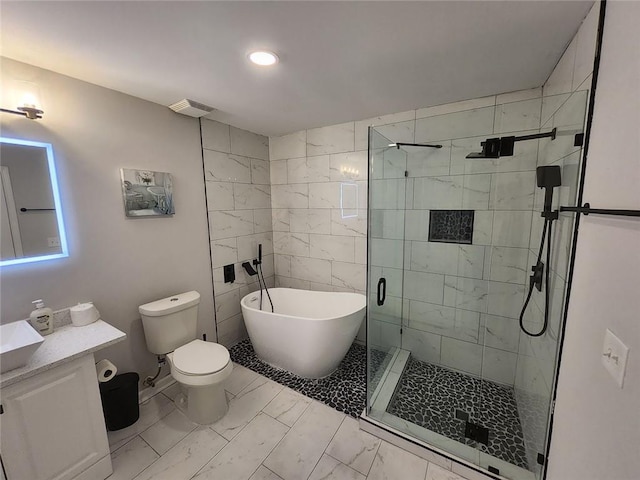 full bathroom featuring a freestanding tub, toilet, vanity, marble finish floor, and a stall shower