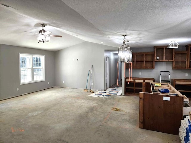 kitchen with dark brown cabinets, ceiling fan, lofted ceiling, and a textured ceiling