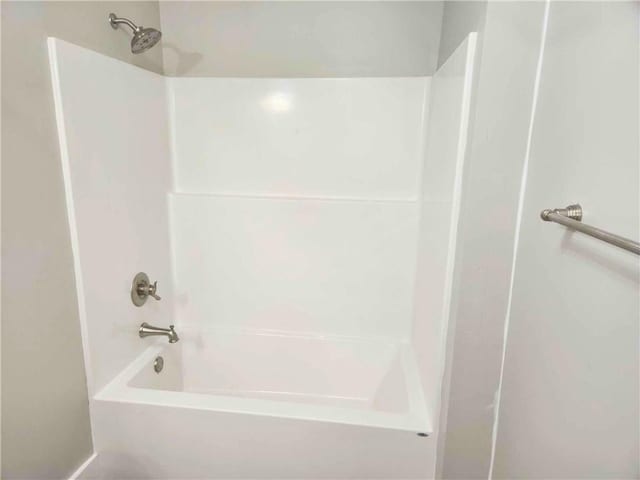 bathroom with shower / washtub combination