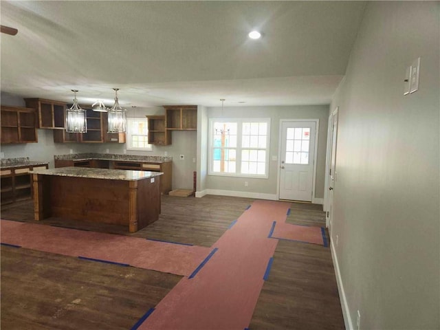 kitchen featuring hanging light fixtures, a center island, and dark hardwood / wood-style floors