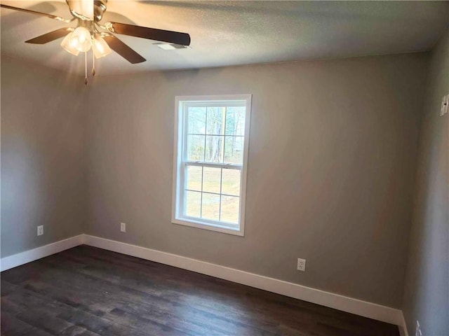 unfurnished room with ceiling fan, a textured ceiling, and dark hardwood / wood-style flooring