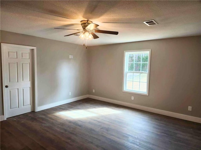 unfurnished bedroom with ceiling fan, dark hardwood / wood-style floors, and a textured ceiling