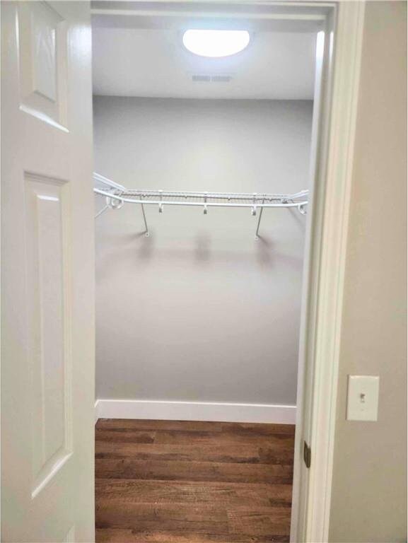 bathroom with a tile shower, vanity, a textured ceiling, and toilet