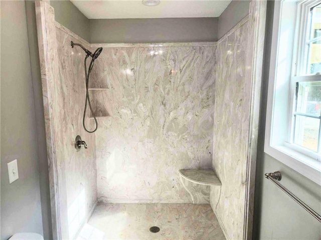 bathroom with tiled shower