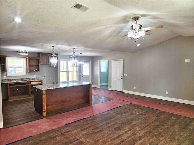 kitchen featuring plenty of natural light, a center island, dark wood-type flooring, and decorative light fixtures