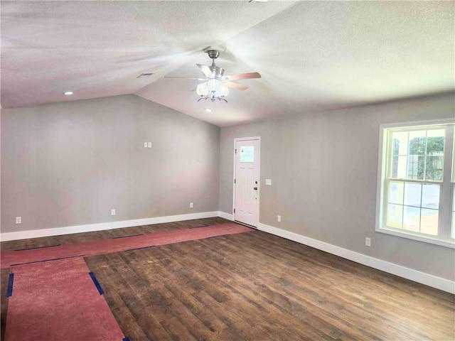 interior space featuring a textured ceiling, wood-type flooring, ceiling fan, and vaulted ceiling