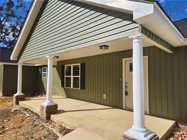 view of exterior entry featuring a porch