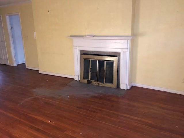 interior details featuring baseboards, a fireplace with flush hearth, and wood finished floors