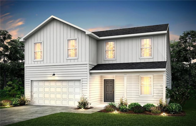 view of front of house featuring a yard and a garage