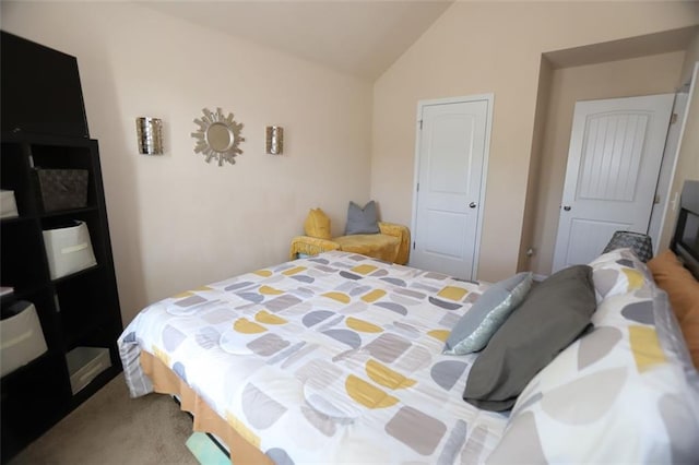 bedroom with vaulted ceiling and carpet floors