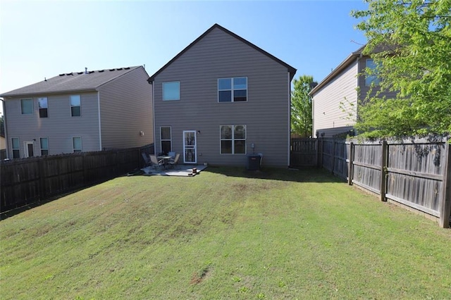 back of house featuring central AC unit, a fenced backyard, a patio, and a lawn