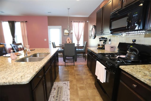 kitchen with a sink, dark brown cabinets, black appliances, decorative backsplash, and light stone counters