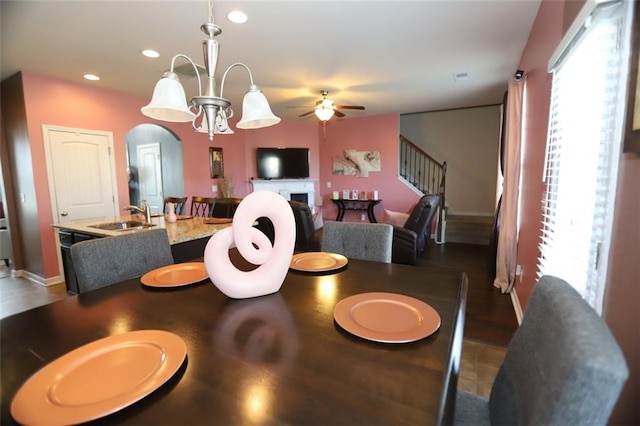 dining area featuring a ceiling fan, arched walkways, recessed lighting, and a healthy amount of sunlight