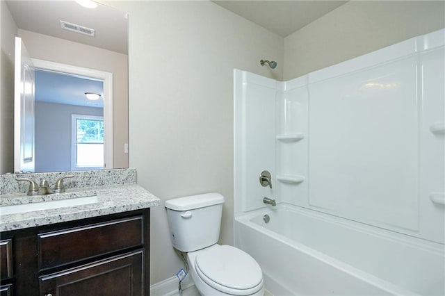 bathroom with vanity, toilet, visible vents, baseboards, and shower / washtub combination