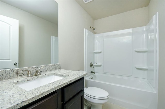 bathroom with washtub / shower combination, vanity, and toilet