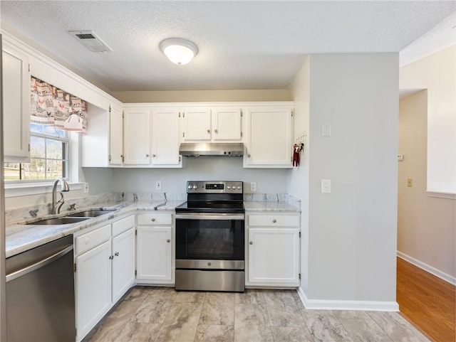 kitchen featuring visible vents, exhaust hood, white cabinets, stainless steel appliances, and a sink