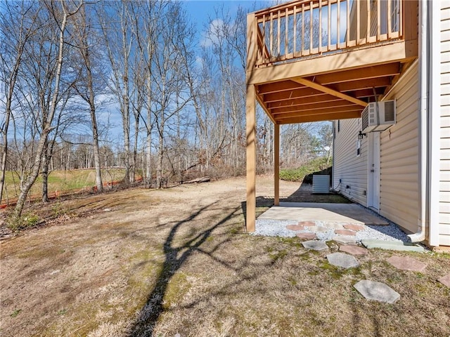 view of yard featuring a wall mounted AC and a patio area