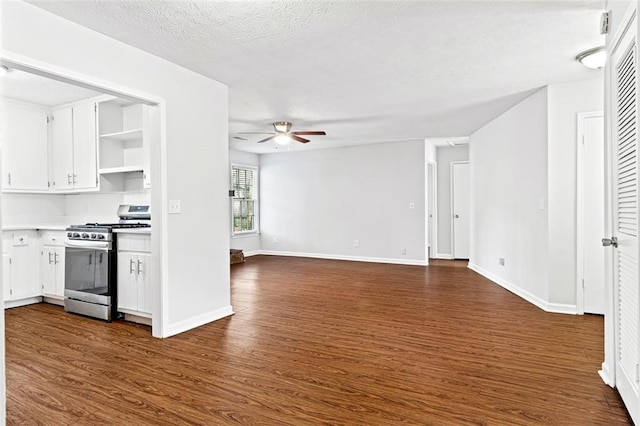 2199 Summertown Dr, Norcross, GA 30071 - kitchen with stainless steel gas range, ceiling fan, dark wood-style floors, white cabinets, and open shelves